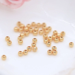 Macro shot of 18K gold plated polished round beads for DIY jewelry making