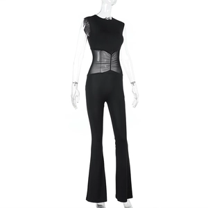 Detail of black sleeveless jumpsuit featuring sheer mesh patchwork and pleated waist