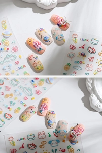 Detail of 5D embossed nail stickers featuring colorful cartoon animals and graffiti art