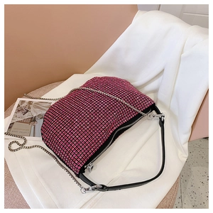 Detail of shimmering rose red rhinestones on a fashion shoulder bag with silver chains