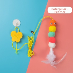 Close-up of hanging cat toy featuring a plush caterpillar with a bell and feathers
