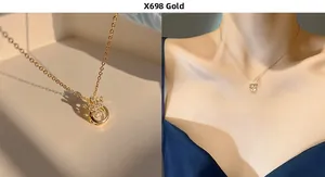 Detail of gold crown necklace with shimmering center stone and elegant O-chain