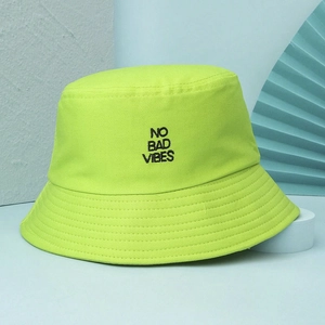 Close-up of NO BAD VIBES embroidery on fluorescent green cotton bucket hat