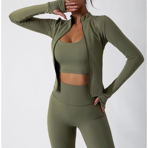 Detailed shot of olive green yoga set featuring thumbholes and high-waist fitness leggings
