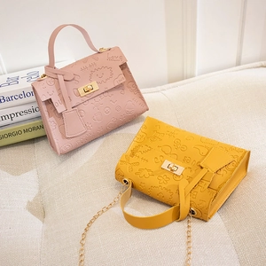 Chic cartoon embossed crossbody bags in pink and yellow with gold chain straps