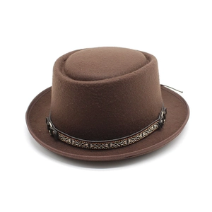 Brown wool pork pie hat with ethnic woven band and leather trim on white background