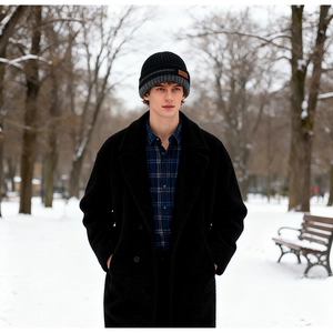 Men's thick knit beanie with fleece lining and leather patch detail in snow setting