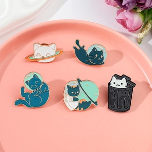 Set of 5 creative space cat enamel pins on a pink plate with floral accents