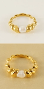 Detail of a 18k gold plated twisted rope ring featuring a natural white pearl accent