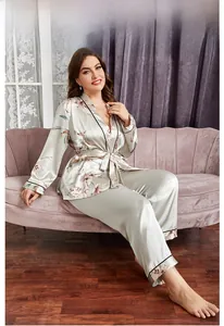 Floral champagne satin pajama set featuring a tie-waist robe and contrasting black trim details