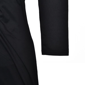 Close-up detail of soft elastic fabric and stitching on the black long-sleeve dress cuff