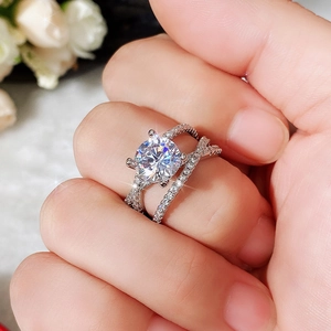 Macro shot of a classic four-prong zircon ring with crisscross pave silver bands