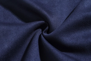 Close-up of deep blue slim fit jacket featuring soft microfiber suede fabric texture