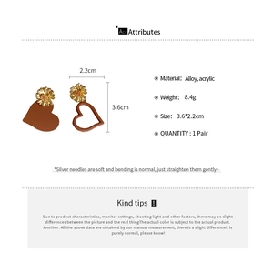 Detailed view showing acrylic heart earrings with dimensions and material specifications