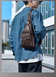 Detailed texture of brown litchi grain leather on a vintage crossbody chest bag for men