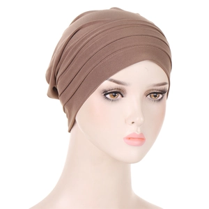 Detail of elegant pleated design on dark brown turban hat for women's hair care
