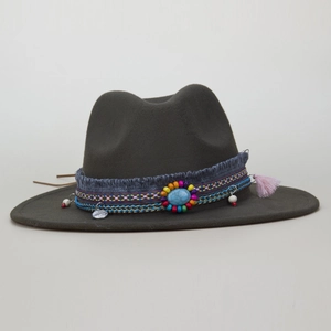 Detail of dark olive wool fedora with woven band, turquoise stone, and pink tassel trim