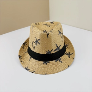 Detail view of woven fedora straw hat with black palm tree patterns and a ribbon band