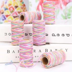 Close-up of assorted two-tone cotton twine rolls for Christmas gift DIY decoration
