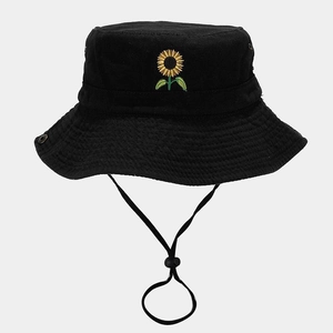 Close-up of embroidered sunflower on a black cotton bucket hat with adjustable chin strap