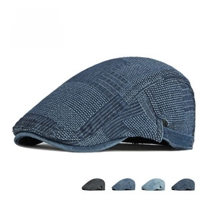 Detail of vintage denim flat cap featuring mixed blue textures and metal side buckle