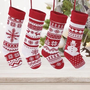 Knitted Christmas stockings with snowflake and reindeer patterns for holiday decoration