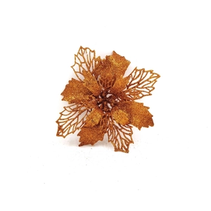Macro detail of gold glitter artificial flower with intricate hollow petals for Christmas