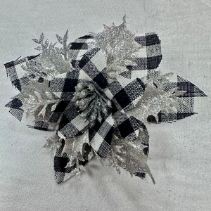 Macro view of black and white buffalo plaid Christmas flower with silver glitter details