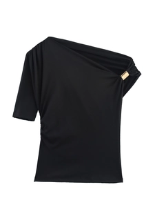 Detailed view of black one-shoulder top featuring a polished gold metal ring accent