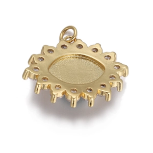 Macro detail of golden sun-shaped pendant back with circular grooves and ring attachment