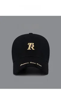 Close-up of golden R letter embroidery and slogan on distressed black baseball cap