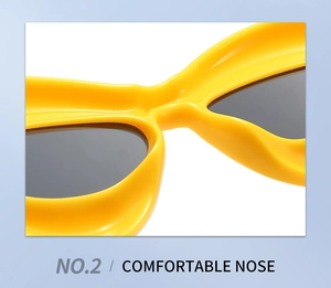 Detail of comfortable nose bridge on yellow cat-eye sunglasses with dark lenses