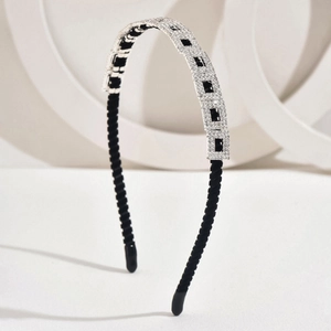 Elegant silver metal headband with sparkling rhinestones and black fabric lining detail