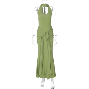 Detail of green halter neck maxi dress featuring a waist knot and elegant flowy ribbons