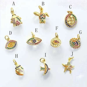 Detailed close-up of colorful zircon-encrusted charms including starfish and evil eye symbols