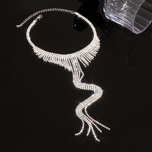 Detail of silver rhinestone fringe necklace showing the shimmering tassel pendant on black mirror