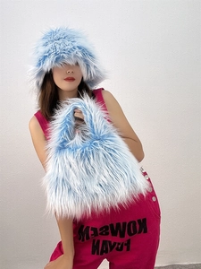 Detail view of light blue faux fur bucket hat and matching plush handbag set
