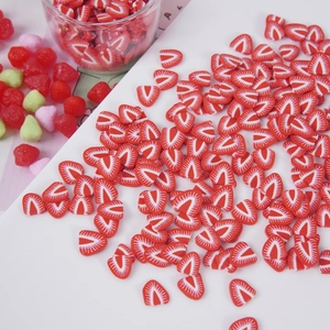 DIY strawberry polymer clay slices for slime and crafts shown in a bright creative setup