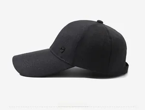 Detailed side view of dark grey baseball cap with metal shield logo and twill texture