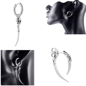 Detail view of retro silver punk earrings with skull charm and spike studs on a model