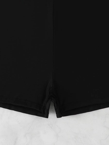Detailed close-up showing the reinforced double-needle stitching on black swim shorts