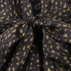 Bohemian loose dress with yellow polka dots, ruffled neckline, and bow tie detail