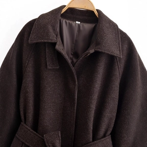 Dark brown wool coat with waist belt on wooden hanger for a stylish winter look