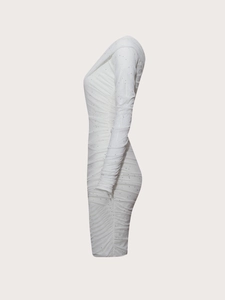 Close-up of white slim fit long sleeve dress with textured ruching and shimmering sequins