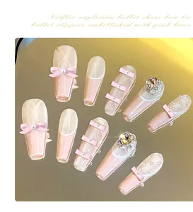 Detailed view of pink Balletcore press-on nails with 3D bows, pearls, and rhinestones