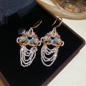 Vintage gold crystal drop earrings with blue beads and cascading silver tassels