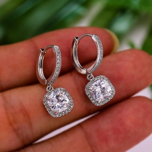 Macro shot of silver halo hoop earrings featuring sparkling square-cut cubic zirconia