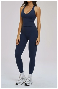 Detailed view of dark blue yoga set featuring a deep V-neck crop top and high waist leggings