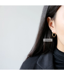 Detail of 15mm small gold hoop earring on model showing minimalist style and size