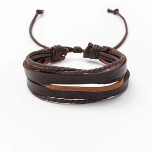 Detailed view of layered brown leather bracelets with intricate braided cord weaving